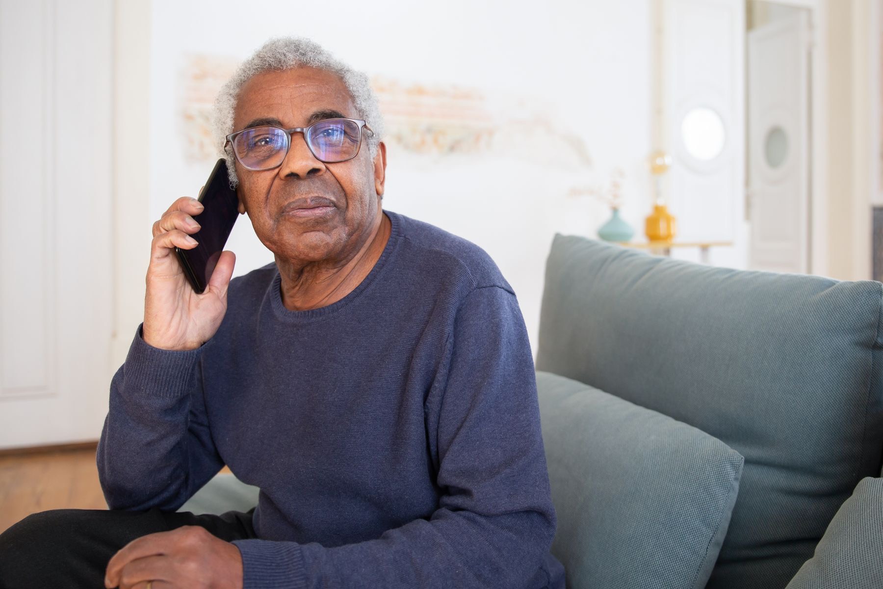 A homeowner talking on the phone at home.